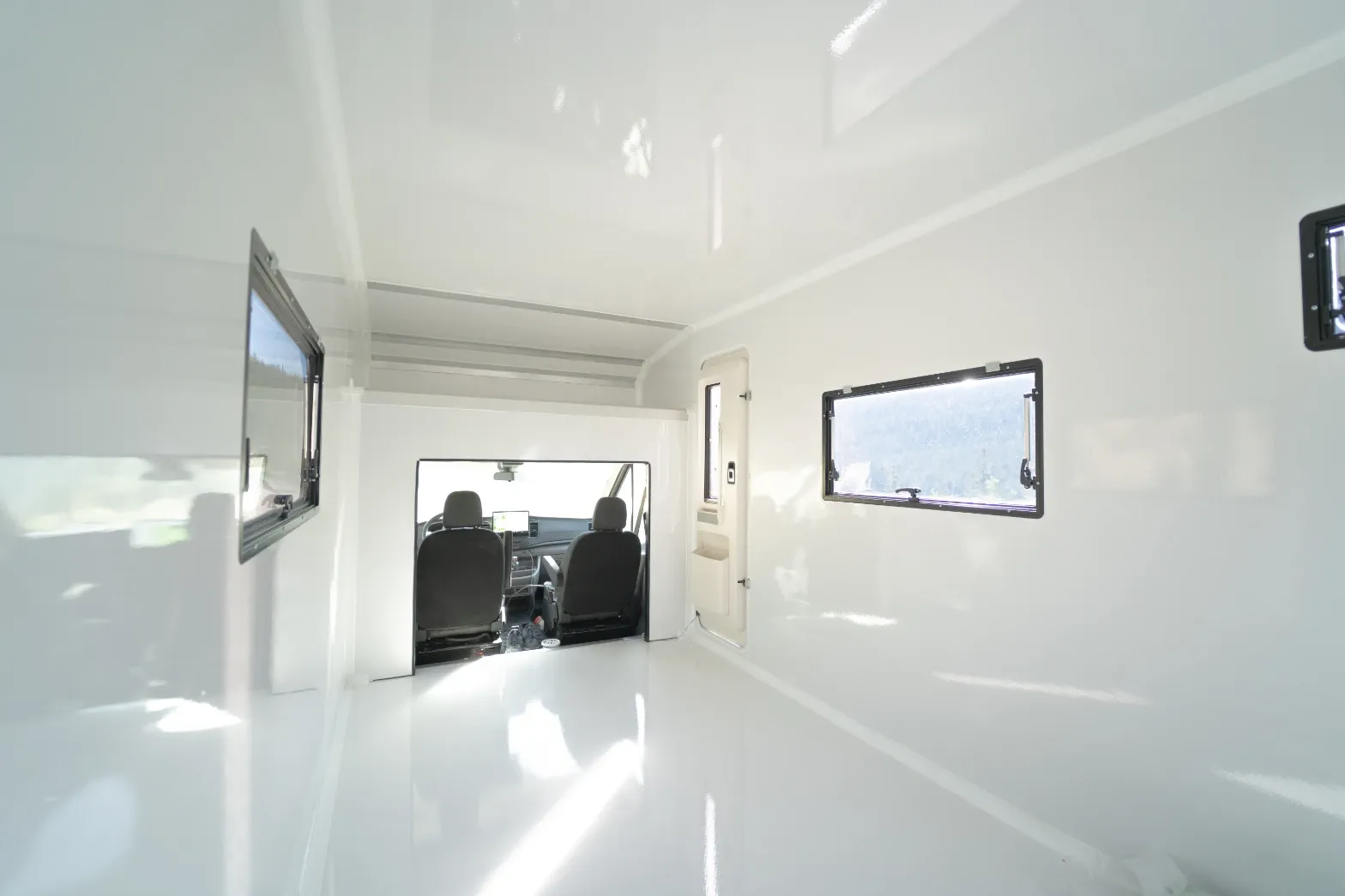 Interior of a white composite body looking through the pass-through to the cab