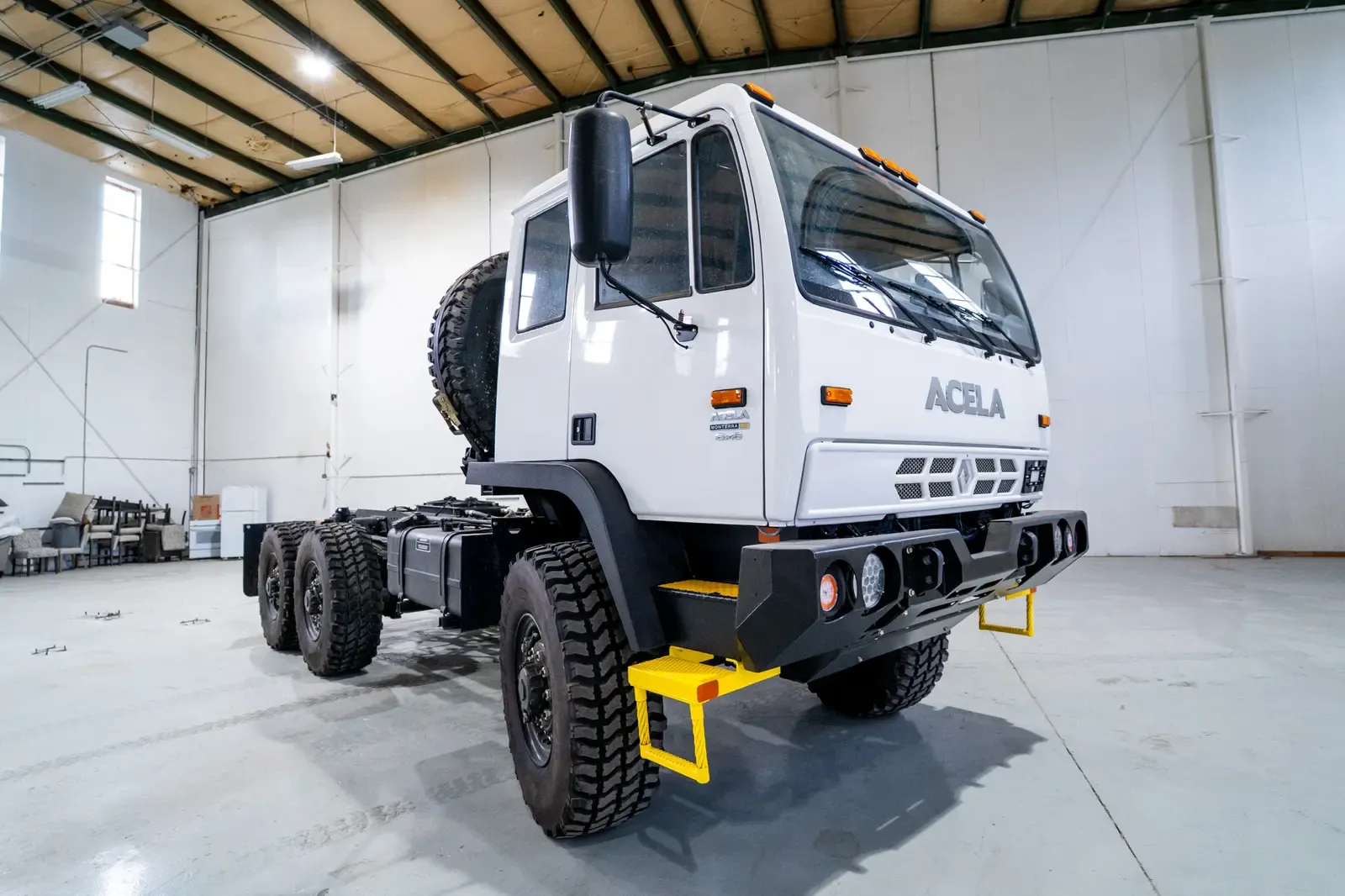 White Acela Monterra 6x6 cab-chassis, front three-quarter view from the driver's side
