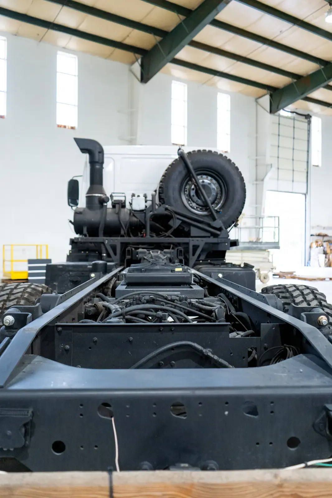 The bare rear frame of the Acela Monterra 6x6, ready for a composite body