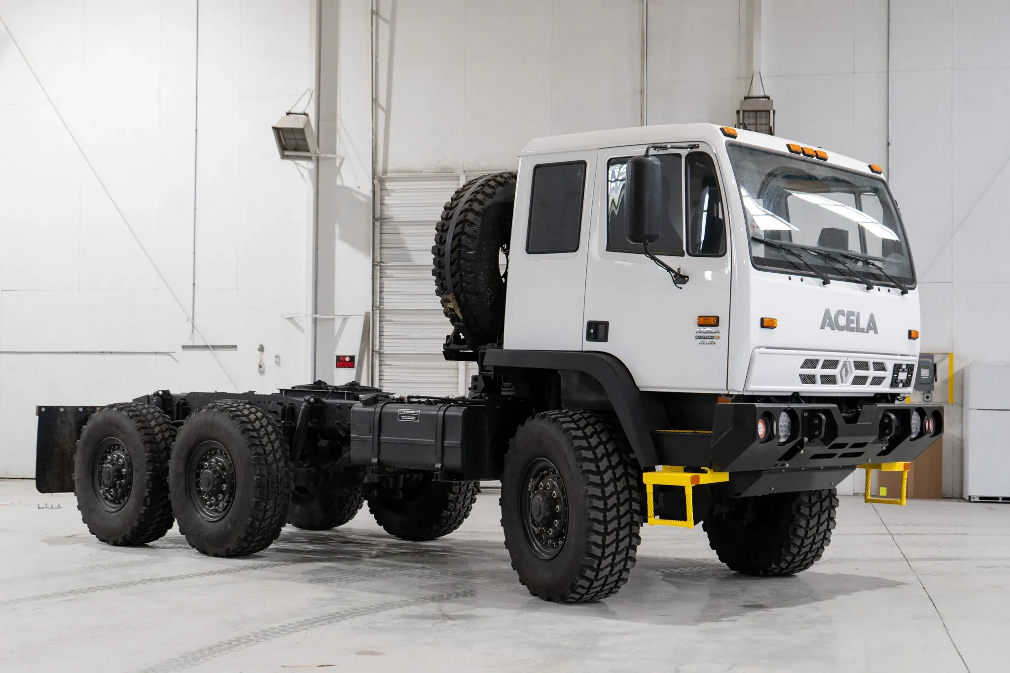 White Acela Monterra 6x6 cab-chassis, body-ready, front three-quarter view in the Foundation Vehicles shop