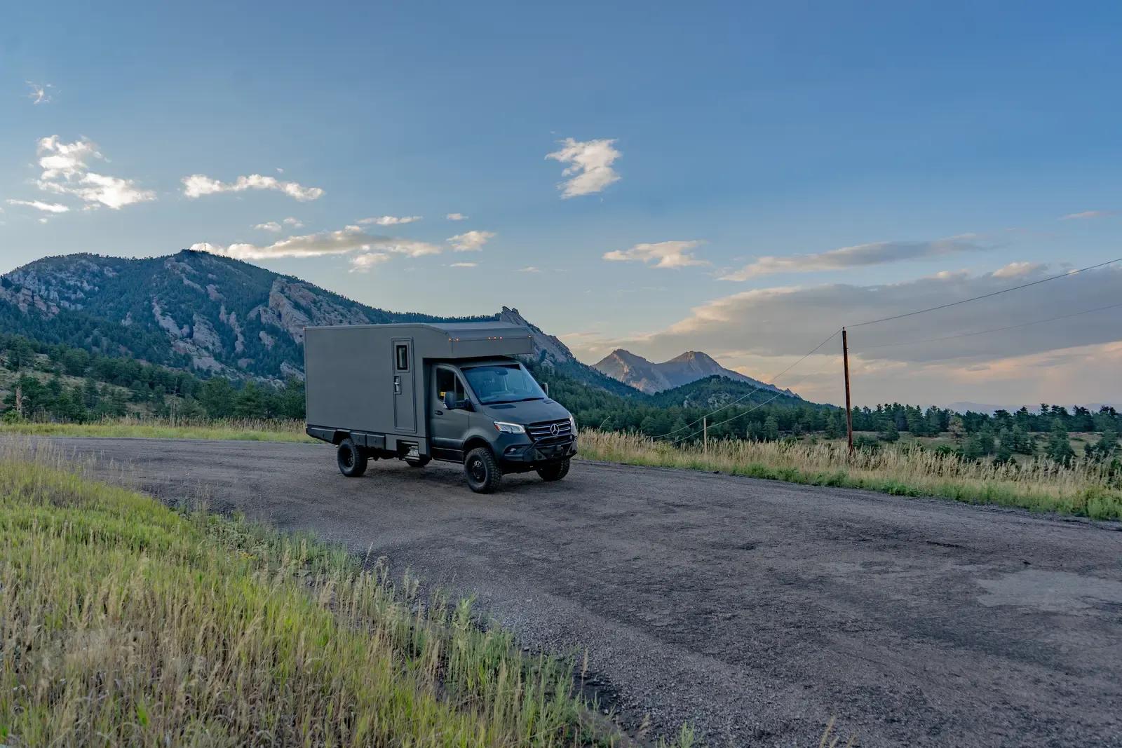 Matte-olive FV-170 demo composite camper on a Mercedes-Benz Sprinter 170, side profile in the evening light