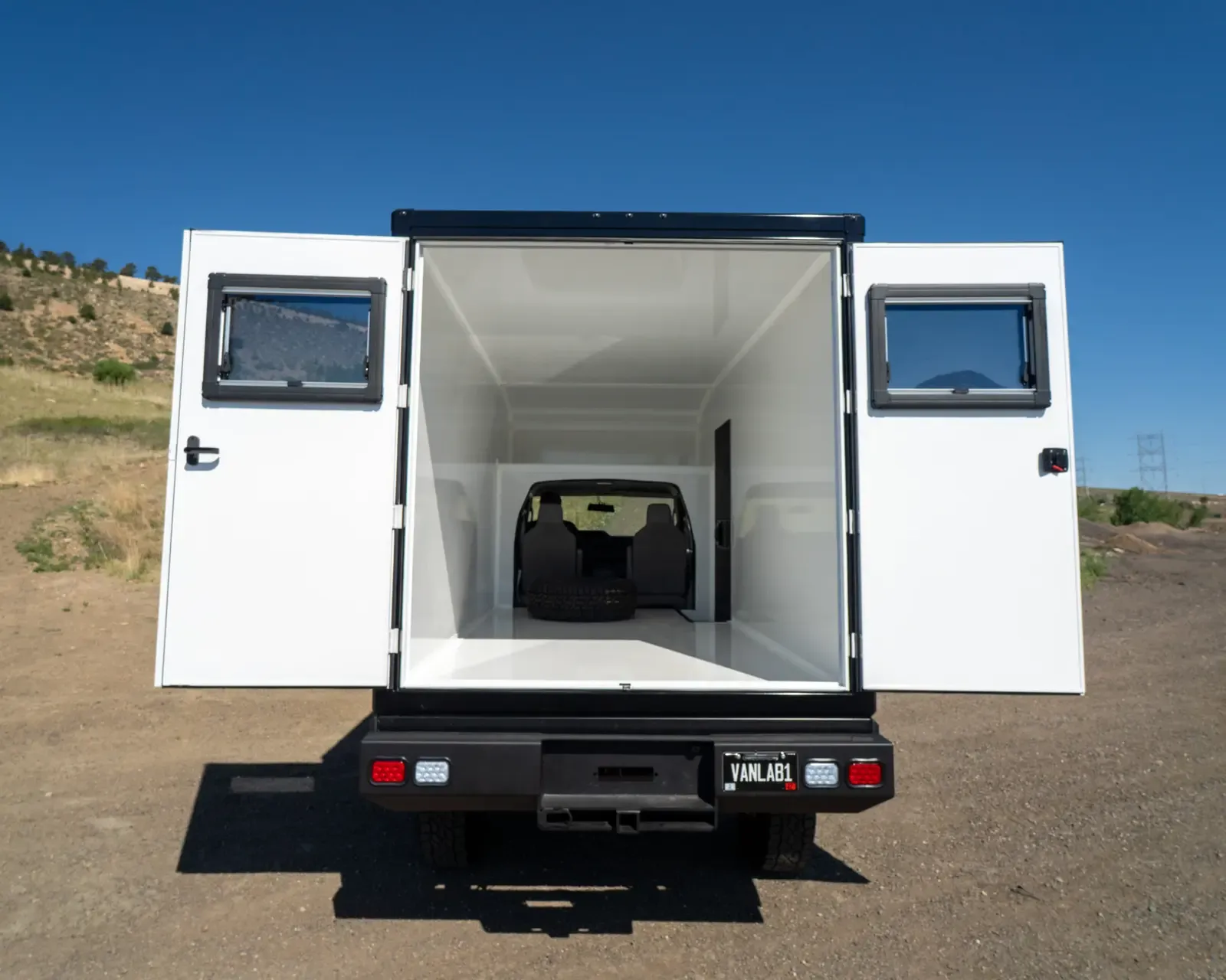 Inside the composite body with the rear barn doors open, showing the bright white interior