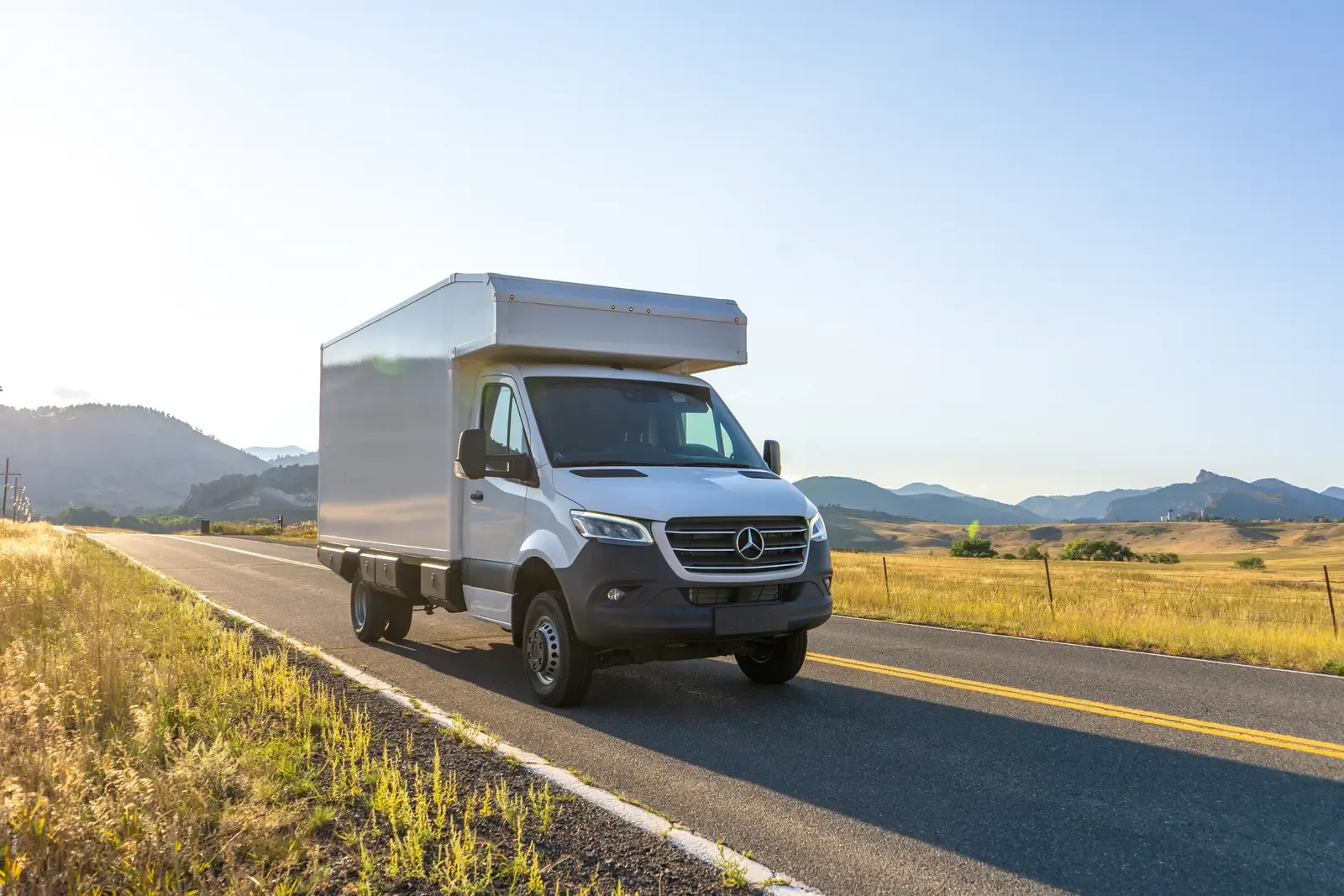 White composite box camper on a Mercedes-Benz Sprinter 170, side profile showing the cabover body